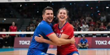 US Paralympic sitting volleyball athletes celebrating victory on court