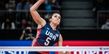 Volleyball's Rising Stars: US Athletes Eyeing International Stardom by 2026 Female US volleyball player spiking powerfully in an international match.